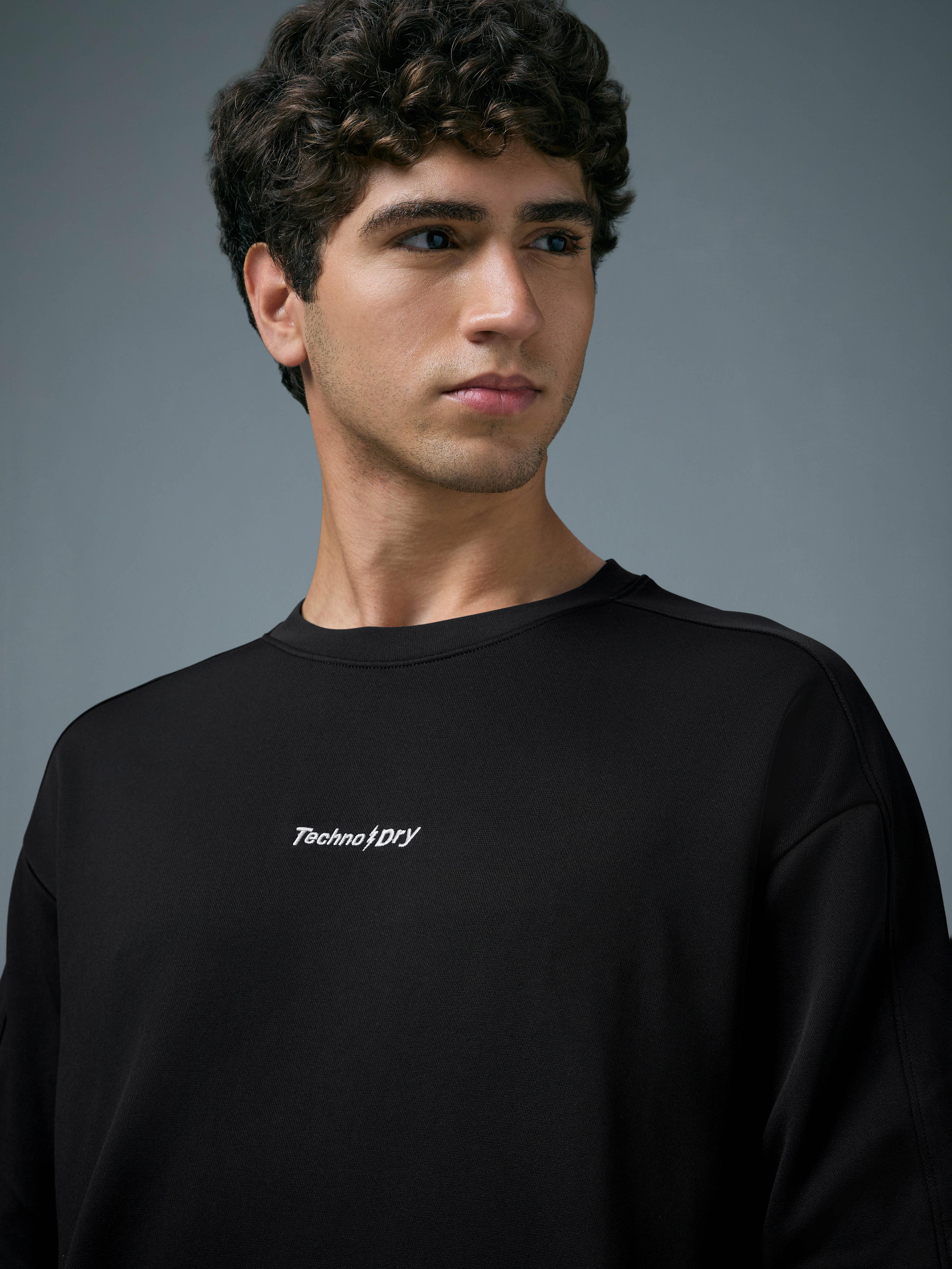 Men Solid Slim Fit Round Neck Sports Sweatshirt with ELASTOPLUS in Black - 6