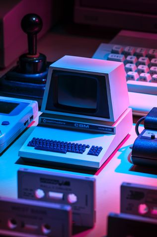 Old consoles stacked on a table.