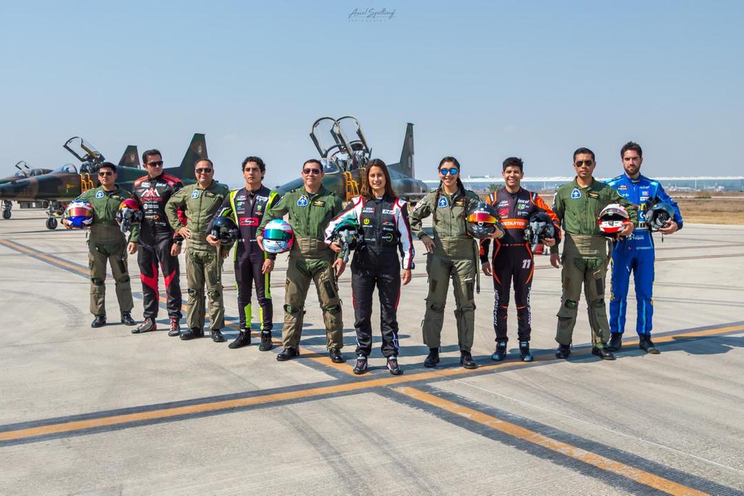 A Tulum airport weekend becomes a global case study at UN Tourism next week Group of pilots and aviation personnel in flight suits standing on an airport tarmac with a military jet aircraft in the background
