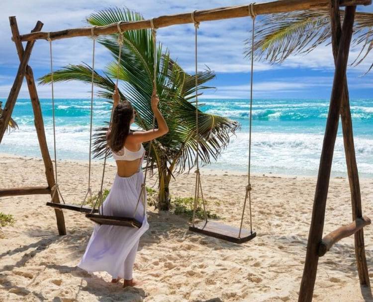 New seasonal vote lets visitors choose their favorite Tulum beach club - Photo 1 Tulum Female Tourist on Swing at Beach