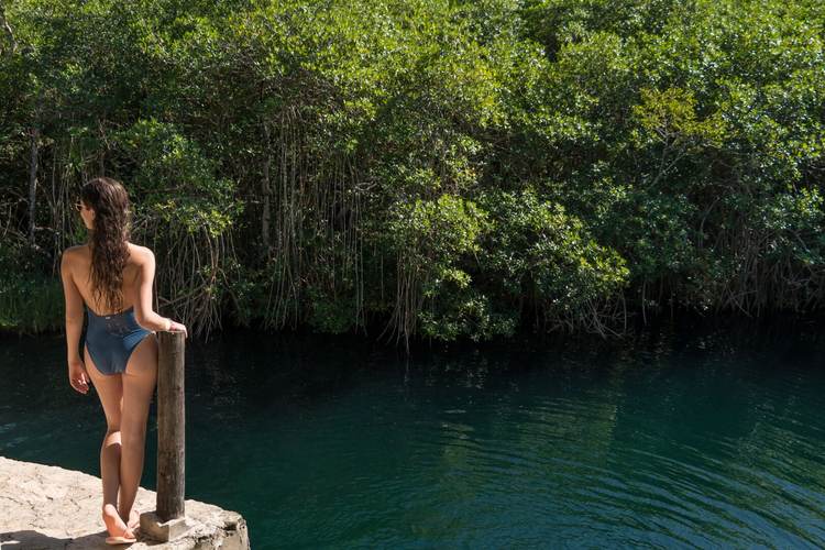 Beautiful woman in a mexican open cenote