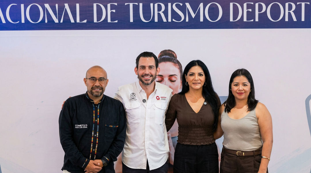 Four people stand in front of a blue banner with Spanish text, smiling at a sports tourism event