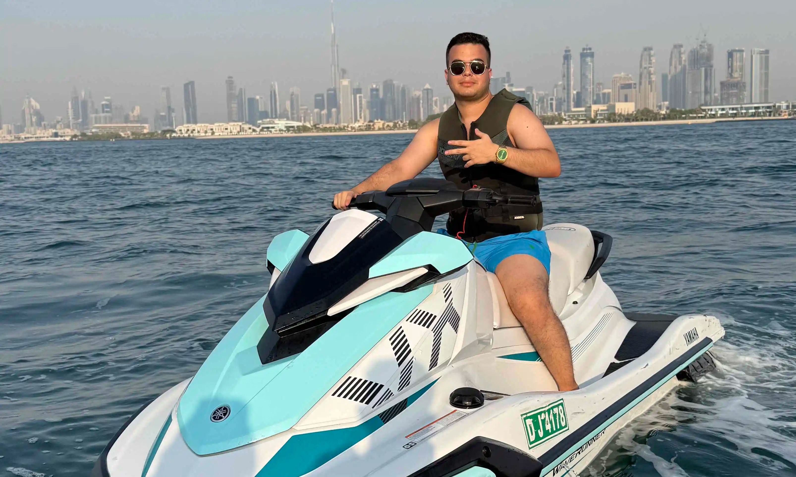 Jet ski in Dubai with clear blue waters and Burj Khalifa visible in the distance.