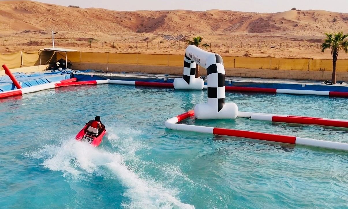 Wide view of Dubai’s only desert jet ski water track with riders enjoying 10 laps.
