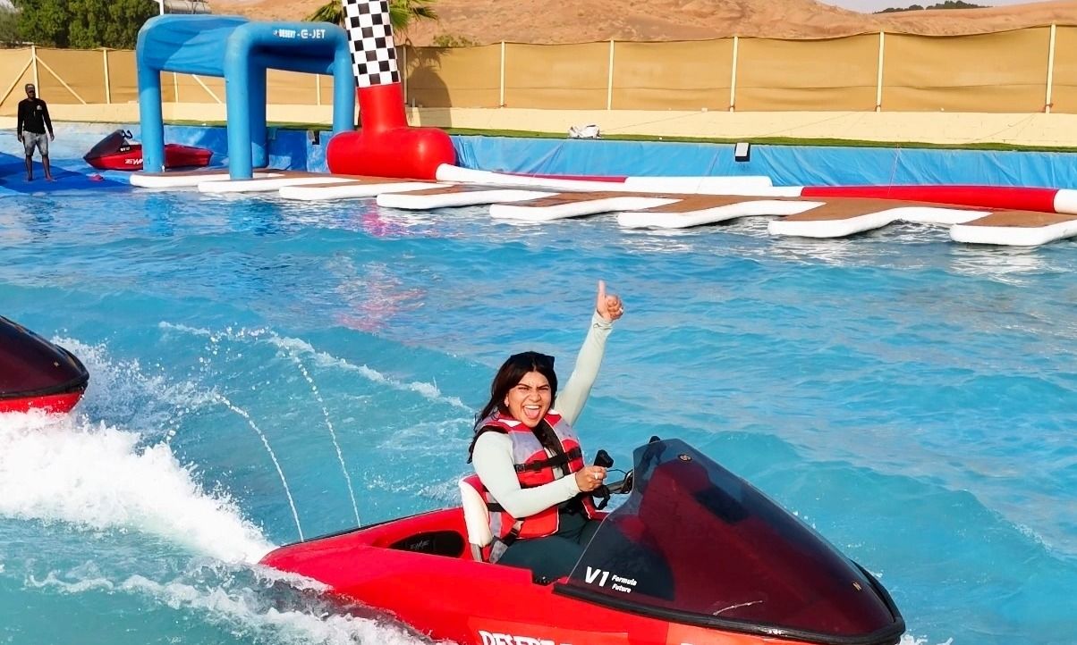 Wide view of Dubai’s only desert jet ski water track with riders enjoying 10 laps.