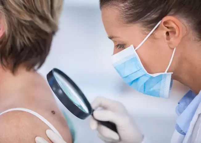 Winchester TN Dermatologist looking at a skin tab