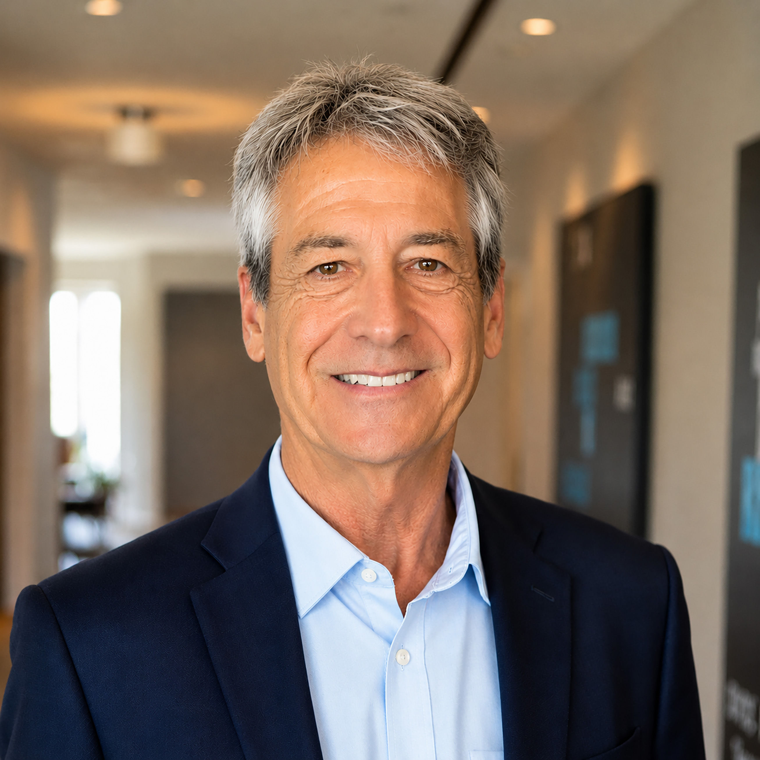 Distinguished senior man with silver hair looking at the camera with quiet confidence