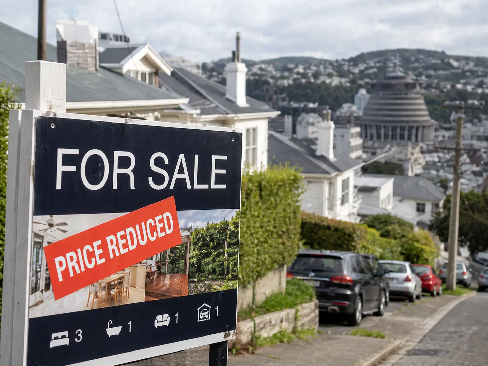 Close-up of a 'For Sale' sign in a suburban Wellington street