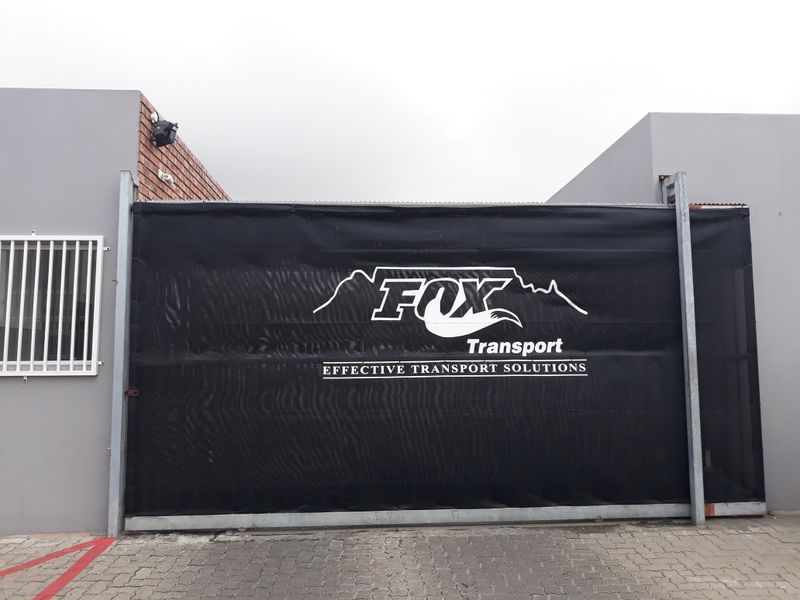 Construction fence covered in branded shadenet