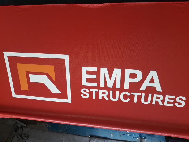 Construction fence wrapped in branded shadenet