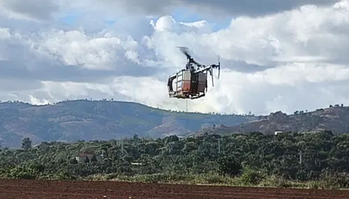 BlueCapHeli® petrol drone helicopter flying an airborne survey over tropical highland terrain