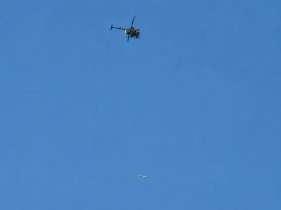 BlueCapHeli® helicopter towing the BlueCapBird® Light magnetometer during magnetic survey testing