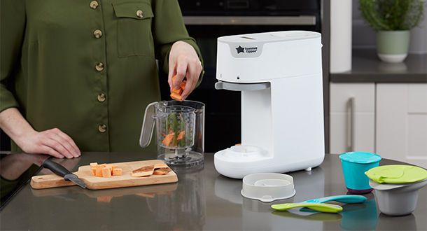 Women placing chopped up carrots into quick-cook container 