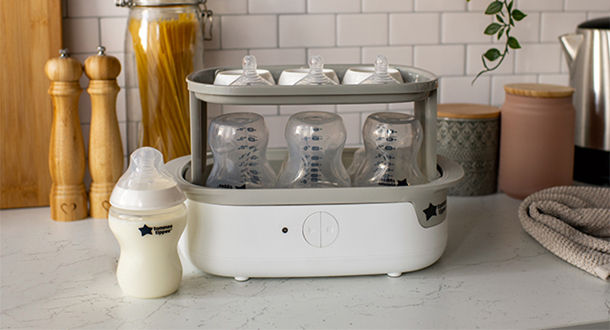 Super steam steriliser on kitchen countertop with Natural Start bottles inside steriliser 