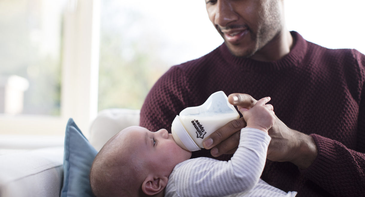 Father feeding baby with natural start bottle 