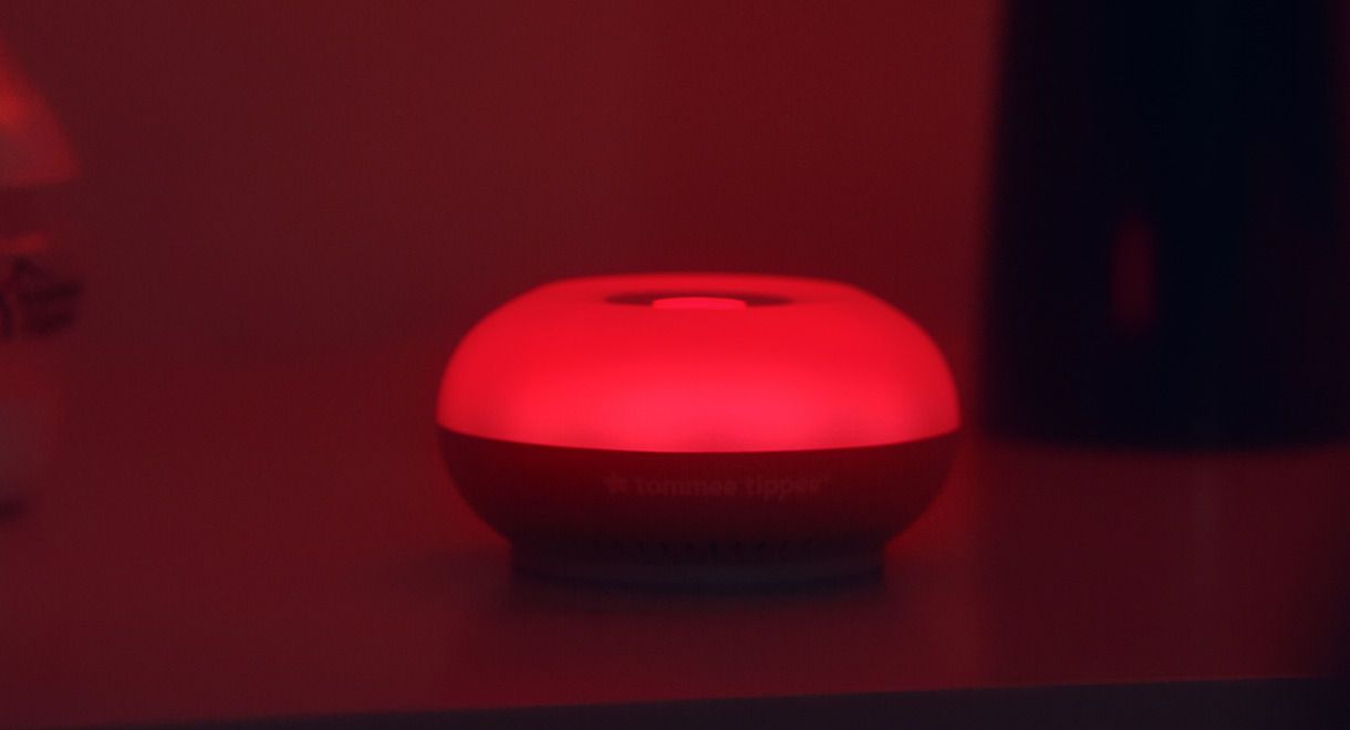 Dreammaker on bedside table emitting red light