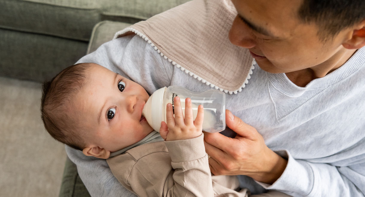 Father feeding baby with natural start bottle 