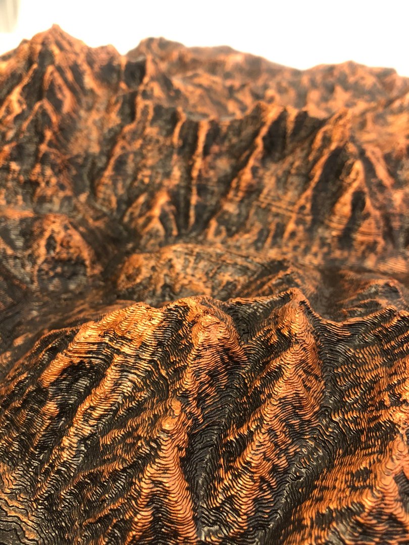 Close-up of an FDM-printed terrain model showing visible layer lines and ridge details