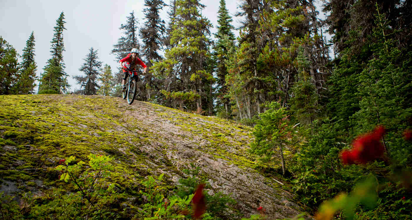 Mountain biker descends a rock face in Smithers BC