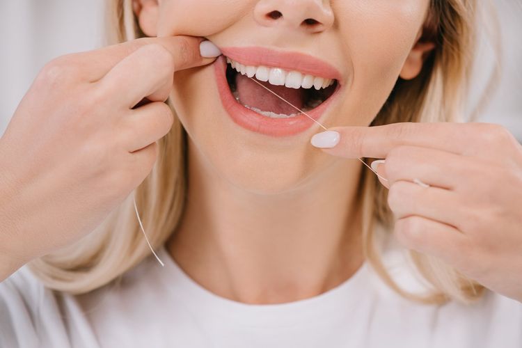 10 Essential Dental Hygiene Tips for 2025 2 cropped view of woman flossing teeth with dental floss