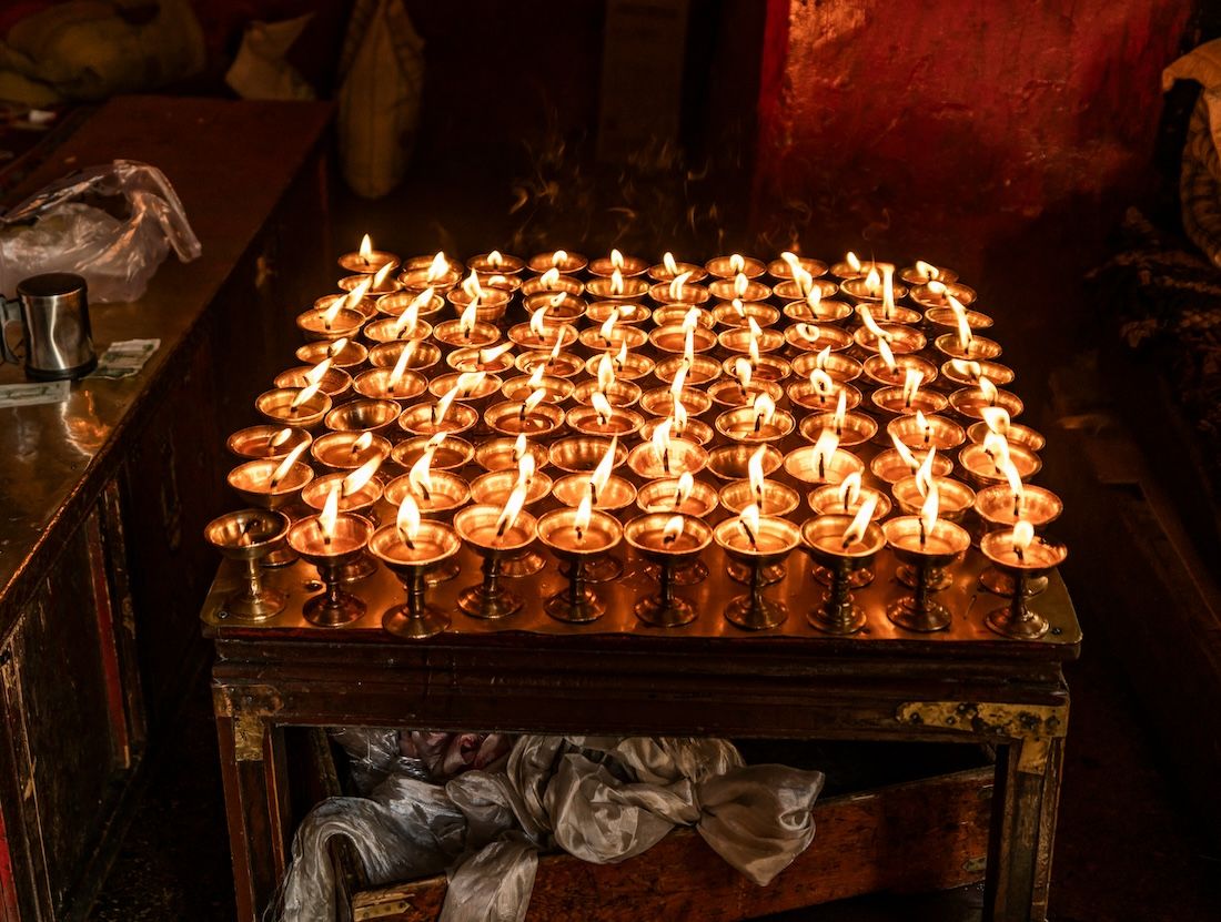 Butter lamps glowing in a monastery