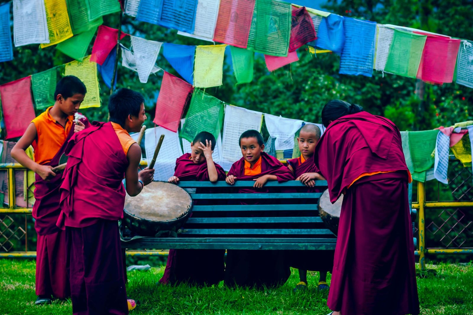 Monks having fun while playing drums