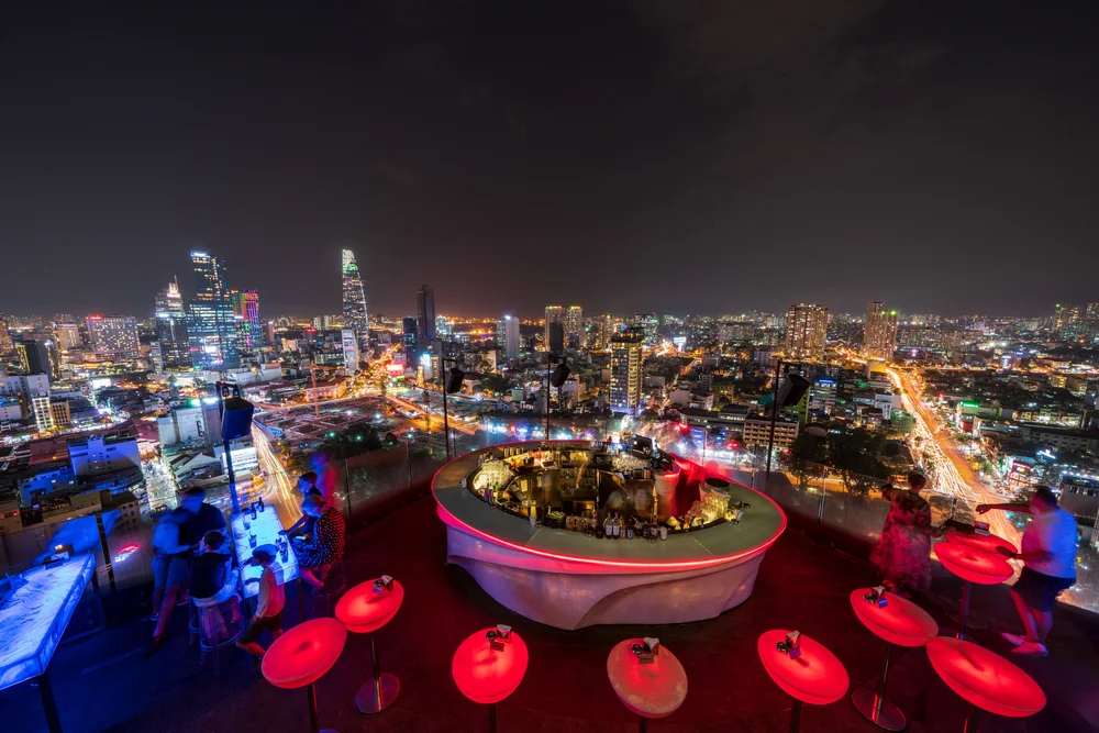 Relax at a rooftop bar overlooking the city skyline