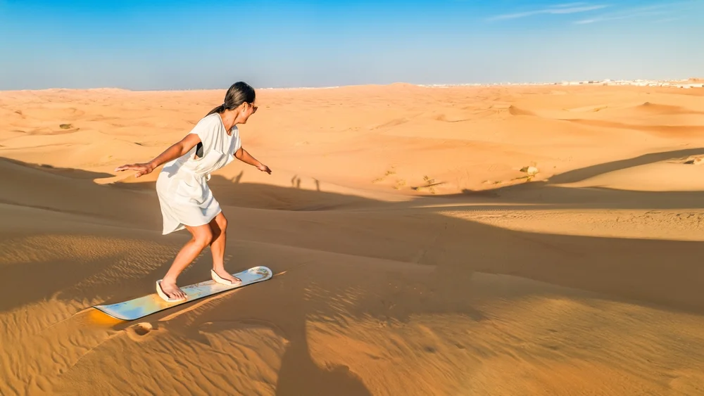 Go quad biking and sandboarding on desert dunes