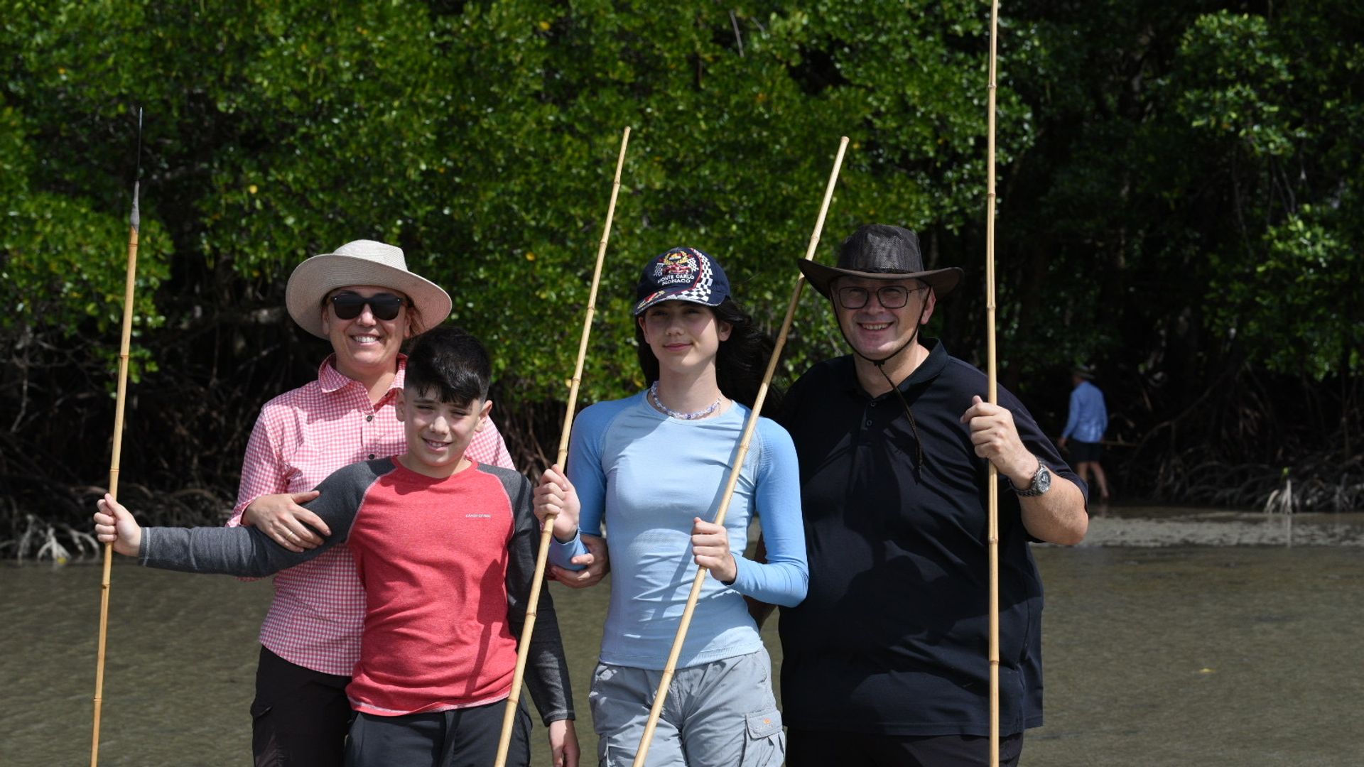 Familie mit traditionellen Speeren während eines kulturellen Walkabout-Erlebnisses mit Aborigines in Australien
