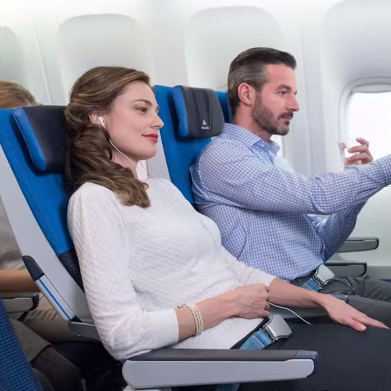 Two people enjoy the inflight entertainment system in Premium Economy