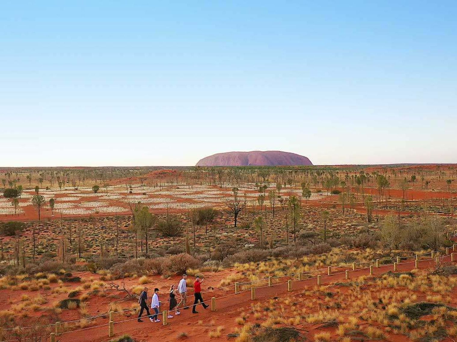 People walking along a path through the Uluru National Park in Australia