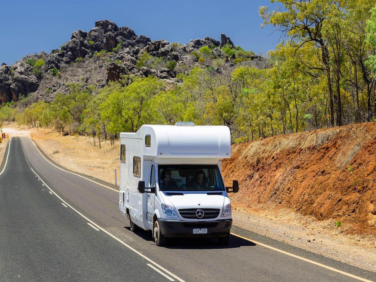 Campervan driving on a road through the Australian outback