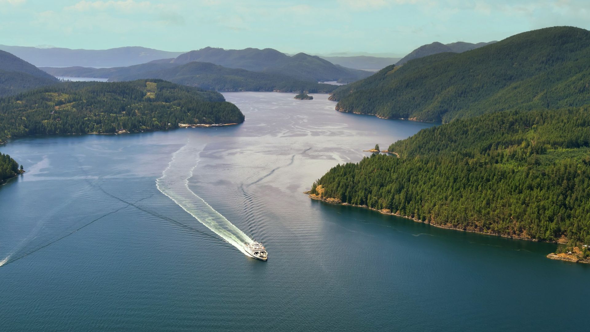 Aerial view over sunshine coast, boat on the water