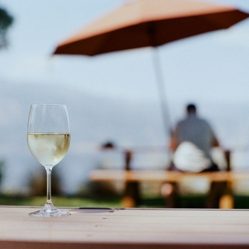 A glass of white wine on a table outside