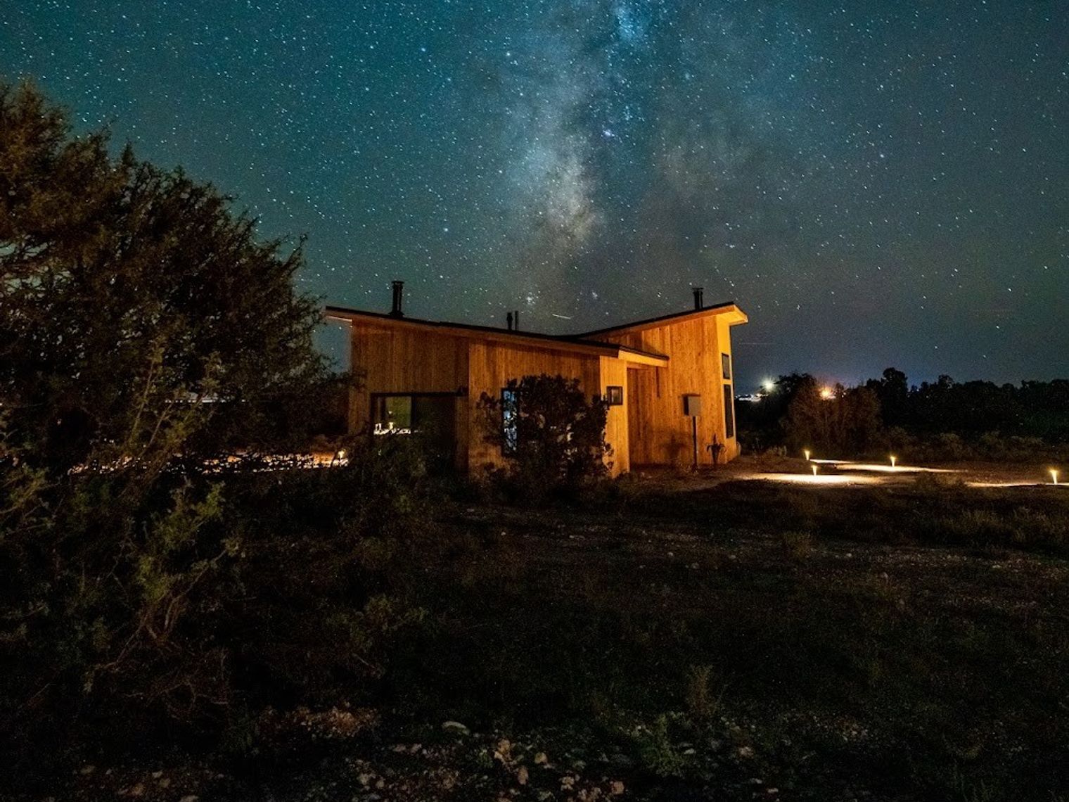 Wooden house accommodation at night, surrounded by stars in the Grand Cayon