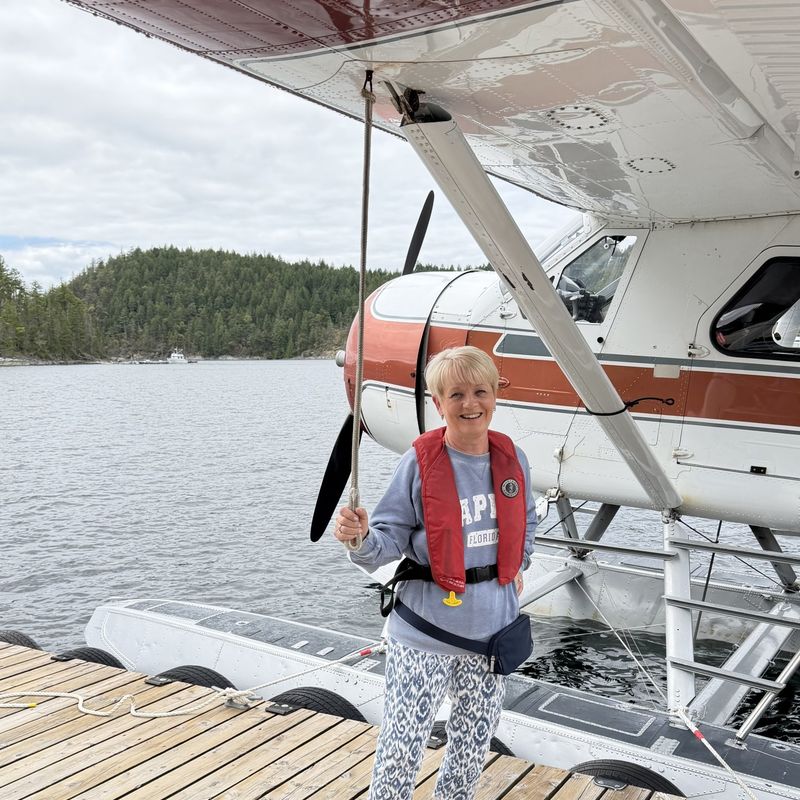 Woman standing in front of sea plane