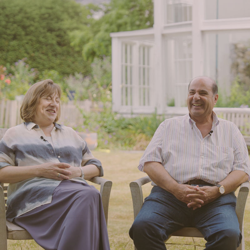 A couple sit in a garden and recall stories of their holiday Down Under