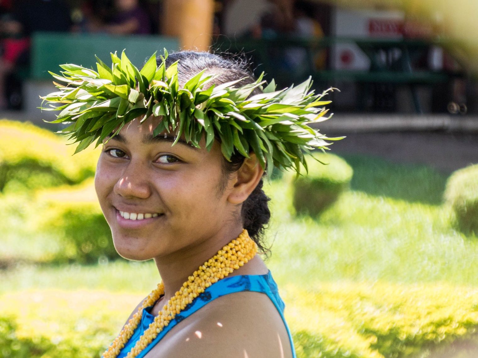 A woman smiling at the camera in a traditional outfit