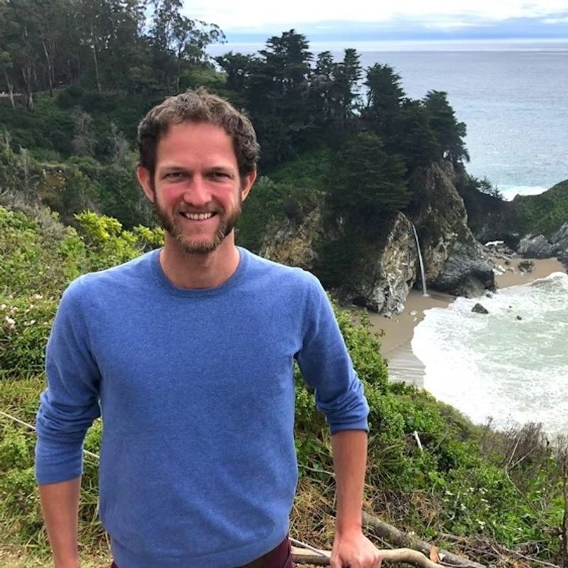 Mann steht vor Bucht mit Wasserfall in den USA