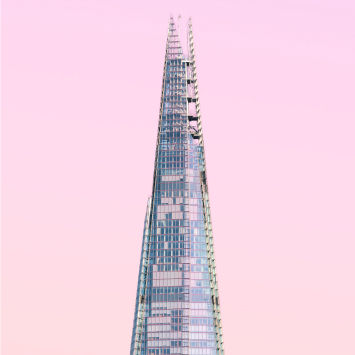 The shard building in london with a pink sky.