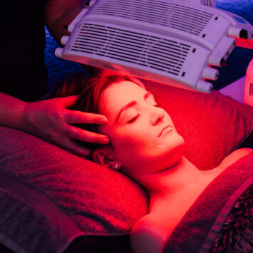 A woman being treated with a red light