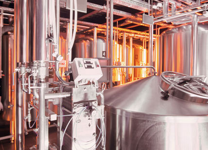 An image of a brewery with stainless tanks, Dinner. Adnams Hotel