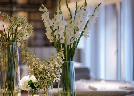 An image of flowers in vases on a table, 5-course tasting menu. Alex Dilling at Hotel Cafe Royal