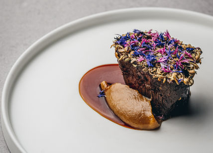 An image of a dessert on a plate, Nine-course tasting menu at the Chef’s Table. Amethyst