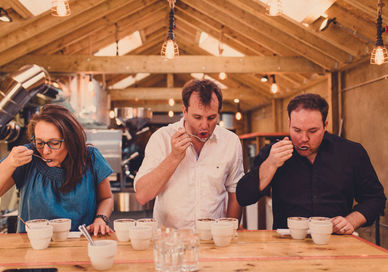 An image of people tasting coffee