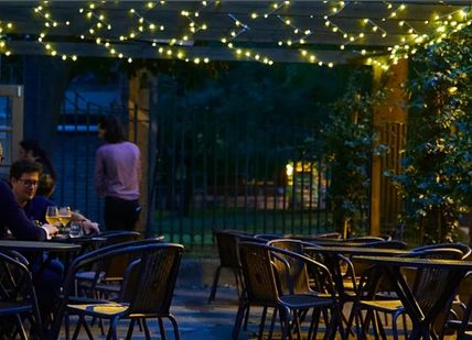 An image of a restaurant with tables and chairs, Wine Tasting Flight. Aspen & Meursault