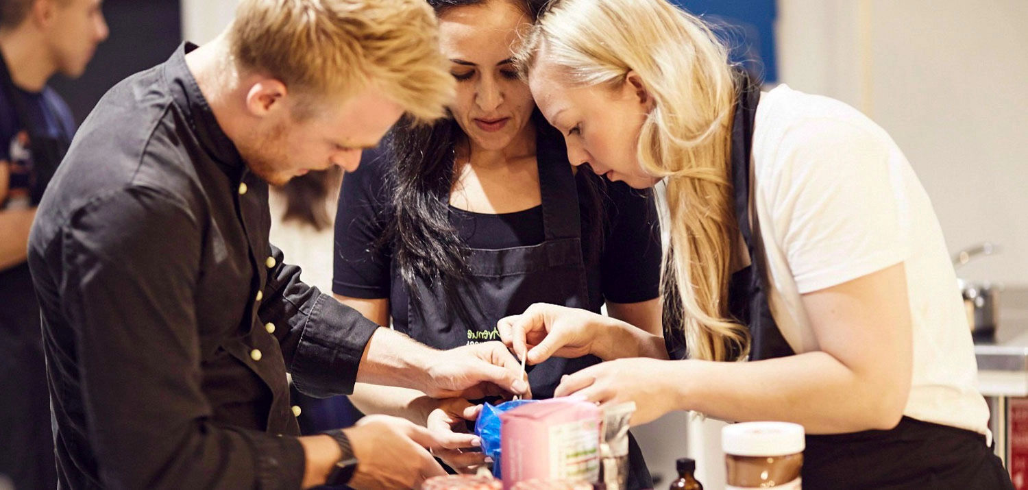 A group of people preparing food in a kitchen