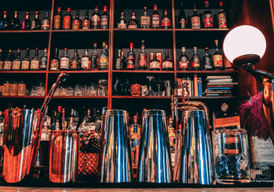 An image of a bar with a lot of bottles, Premium Rum Tasting Masterclass. Black Parrot