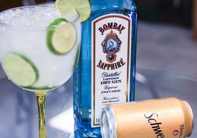 An image of a bottle of rum and a glass of gin, Gin Masterclass with a guided tour. Bombay Sapphire Distillery