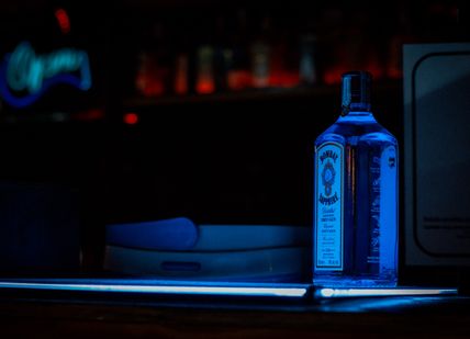 An image of a bottle of alcohol on a table, Gin Masterclass with a guided tour. Bombay Sapphire Distillery